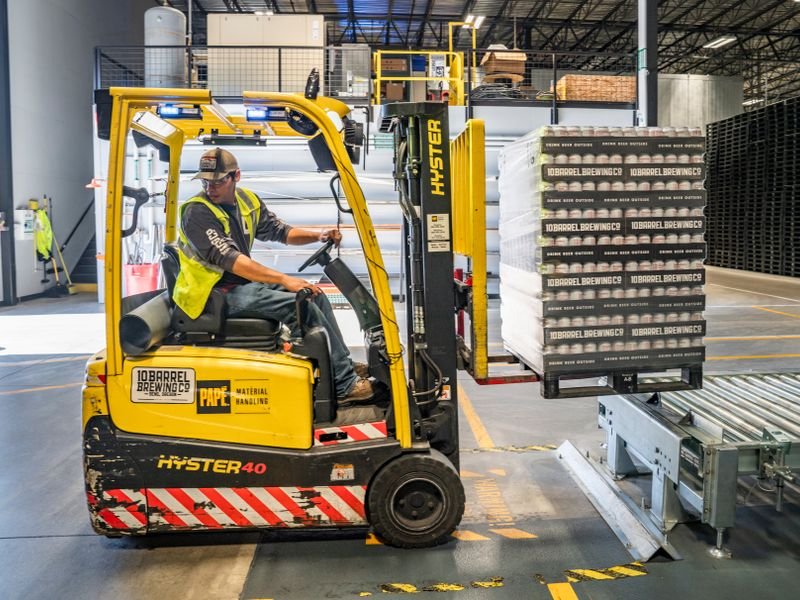Warehouse worker operating a forklift