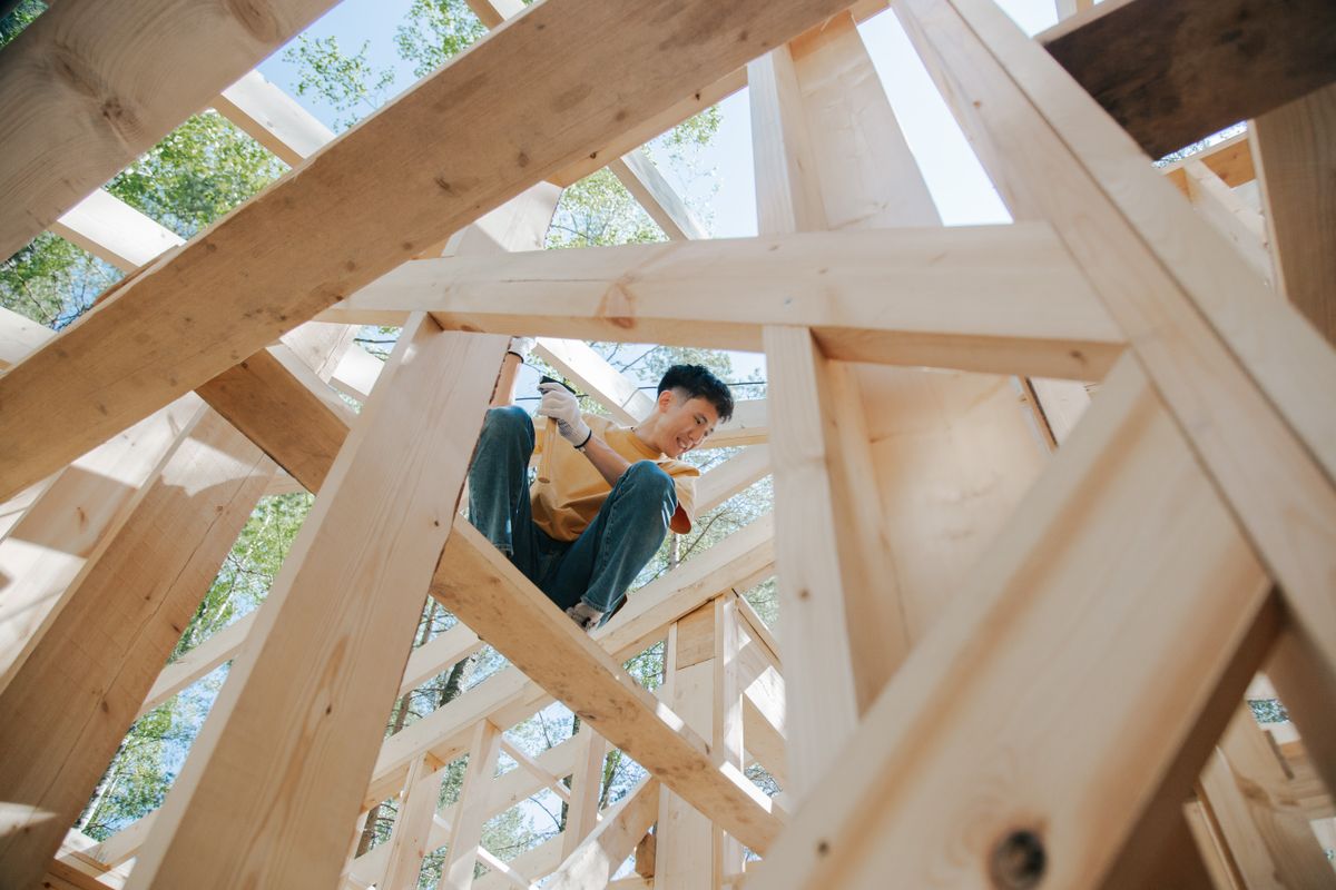 Australian carpenter working on a timber house frame at a construction site
